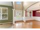 Bright living room with hardwood floors, columns, and a view to the front lawn and dining area at 150 Fitzroy Ln, Acworth, GA 30101