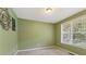 Cozy, carpeted room with soft green walls, a window, and natural light at 150 Fitzroy Ln, Acworth, GA 30101