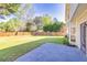 Expansive backyard features a well-maintained lawn, wood fence, and a patio area perfect for outdoor enjoyment at 210 Chandler Ct, Sugar Hill, GA 30518