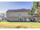 Large backyard showcasing the home's exterior, a well-kept lawn, and a patio area for relaxation and gatherings at 210 Chandler Ct, Sugar Hill, GA 30518