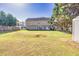 Spacious backyard with a large lawn area, shed, and patio, ideal for outdoor activities and entertaining at 210 Chandler Ct, Sugar Hill, GA 30518