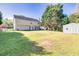 Expansive backyard with a storage shed, mature trees, and a well-manicured lawn perfect for recreation at 210 Chandler Ct, Sugar Hill, GA 30518
