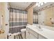 A well-lit bathroom includes a single sink vanity, toilet and shower featuring a full length mirror at 210 Chandler Ct, Sugar Hill, GA 30518