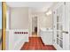 The bright and spacious bathroom features a bathtub, shower and separate vanity, offering comfort and functionality at 210 Chandler Ct, Sugar Hill, GA 30518