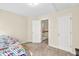 Well-lit bedroom with neutral walls, carpeted floor, and two closets, creating a cozy and inviting atmosphere at 210 Chandler Ct, Sugar Hill, GA 30518