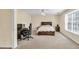 Bright bedroom with a ceiling fan, large window, work space, and comfortable bed, offering a peaceful retreat at 210 Chandler Ct, Sugar Hill, GA 30518