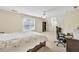 Bright bedroom with a ceiling fan, large window, work space, and comfortable bed, offering a peaceful retreat at 210 Chandler Ct, Sugar Hill, GA 30518