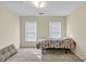 Well-lit bedroom with neutral walls and soft carpeting, creating a cozy and inviting atmosphere at 210 Chandler Ct, Sugar Hill, GA 30518