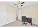 Inviting bedroom features a ceiling fan, a window providing natural light and a desk with an office chair at 210 Chandler Ct, Sugar Hill, GA 30518