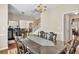 Elegant dining room boasting a dark wood dining table, chandelier lighting, and views of the staircase at 210 Chandler Ct, Sugar Hill, GA 30518