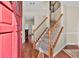 Inviting foyer with hardwood floors, a staircase with white railings, and a view into the living area at 210 Chandler Ct, Sugar Hill, GA 30518