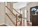Welcoming foyer with staircase, hardwood floors, and views into the dining room at 210 Chandler Ct, Sugar Hill, GA 30518