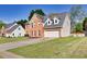 Beautiful brick home with a well-manicured lawn and a two-car garage in a nice neighborhood at 210 Chandler Ct, Sugar Hill, GA 30518