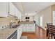 Kitchen boasts granite countertops and stainless-steel appliances at 210 Chandler Ct, Sugar Hill, GA 30518