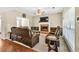 Inviting living room with a fireplace, hardwood flooring, a comfortable sectional, and plenty of natural light at 210 Chandler Ct, Sugar Hill, GA 30518