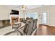 Living room showcasing fireplace, TV, ceiling fan and access to the homes exterior at 210 Chandler Ct, Sugar Hill, GA 30518