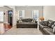 Comfortable living room with carpeted floors, natural light, and views into the entry and dining areas at 210 Chandler Ct, Sugar Hill, GA 30518