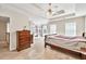 Bright main bedroom boasts a ceiling fan, carpet flooring, built-in shelving, and natural light from the windows at 210 Chandler Ct, Sugar Hill, GA 30518