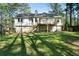 Large backyard with lush lawn, wooden deck, stairs, and fence providing a private outdoor space at 34 Cedar Creek Ct, Acworth, GA 30101