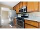 Well-lit kitchen featuring stainless steel appliances and wood cabinetry at 34 Cedar Creek Ct, Acworth, GA 30101