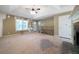 Another angle of a spacious living room featuring a cozy fireplace and ample natural light from large windows at 34 Cedar Creek Ct, Acworth, GA 30101