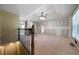 Upstairs view of a spacious living room featuring a cozy fireplace and ample natural light from large windows at 34 Cedar Creek Ct, Acworth, GA 30101