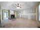 Spacious living room featuring a cozy fireplace and ample natural light from large windows at 34 Cedar Creek Ct, Acworth, GA 30101