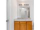 Bathroom with light wood cabinets and a granite countertop vanity with a large mirror at 7806 Poppy Seed Pl, Winston, GA 30187