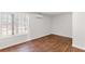 Bedroom featuring a light-filled window, beautiful wood-look flooring, and neutral paint at 7806 Poppy Seed Pl, Winston, GA 30187