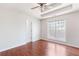 Bedroom with wood floors, neutral walls, tray ceiling, and large window at 7806 Poppy Seed Pl, Winston, GA 30187