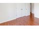 Bedroom with neutral paint and wood-look floors, with a double closet at 7806 Poppy Seed Pl, Winston, GA 30187
