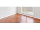 Bedroom with light-filled window, neutral walls, and beautiful wood-look flooring at 7806 Poppy Seed Pl, Winston, GA 30187