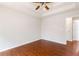 Bedroom with wood floors, neutral walls, and a tray ceiling with ceiling fan at 7806 Poppy Seed Pl, Winston, GA 30187
