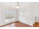 Light-filled dining room with wood floors, neutral walls and large window at 7806 Poppy Seed Pl, Winston, GA 30187