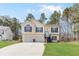 Inviting two-story home featuring a well-manicured lawn, two-car garage, and classic architectural details at 7806 Poppy Seed Pl, Winston, GA 30187