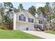 Charming two-story home with a well-maintained lawn, two-car garage and inviting front stairs at 7806 Poppy Seed Pl, Winston, GA 30187