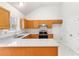 Well-lit kitchen featuring granite counters, stainless steel appliances, wood cabinets, and a double sink at 7806 Poppy Seed Pl, Winston, GA 30187