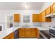 Bright kitchen with wood cabinets, stainless steel appliances and granite countertops at 7806 Poppy Seed Pl, Winston, GA 30187
