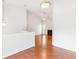 Open living room with wood floors, fireplace, and view to the dining room at 7806 Poppy Seed Pl, Winston, GA 30187