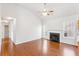 Open living room featuring hardwood floors, a fireplace, a ceiling fan, and a back door at 7806 Poppy Seed Pl, Winston, GA 30187