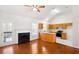 Cozy living area with a fireplace, back door, and an open layout to the adjacent kitchen with modern appliances at 7806 Poppy Seed Pl, Winston, GA 30187