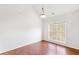 Bright room with wood floors, neutral walls, vaulted ceiling, and large window at 7806 Poppy Seed Pl, Winston, GA 30187