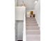 Bright entryway featuring a carpeted staircase with white banister, leading to the upper level of the home at 7806 Poppy Seed Pl, Winston, GA 30187