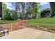 Backyard featuring a wood deck overlooking the grassy lawn and mature trees at 225 Valley Dr, Roswell, GA 30075