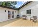 Exterior showcasing a white-painted brick home with an open deck and patio furniture at 225 Valley Dr, Roswell, GA 30075