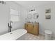 Bright bathroom featuring standalone tub, stylish vanity and lighting, plus decorative tile at 225 Valley Dr, Roswell, GA 30075
