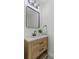 Bathroom with a wooden vanity, modern mirror and lighting at 225 Valley Dr, Roswell, GA 30075