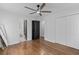 Bedroom with hardwood floors, black doors, walk in closet, and neutral walls at 225 Valley Dr, Roswell, GA 30075