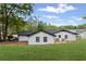 Home exterior with a large backyard and patio area, surrounded by lush landscaping at 225 Valley Dr, Roswell, GA 30075