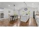 Open-concept kitchen with a pantry and dining area adjacent to the kitchen island and stainless appliances at 225 Valley Dr, Roswell, GA 30075